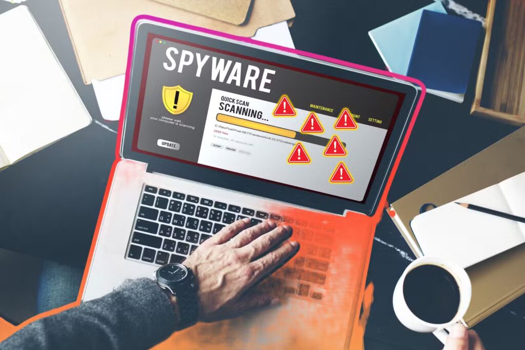 person using laptop for spyware scan with warning signs